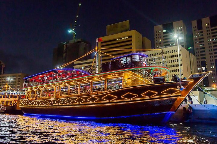 Experience the charm of Dubai Creek on a traditional dhow enjoying a delightful BBQ buffet dinner soothing music and stunning views of the illuminated skyline.